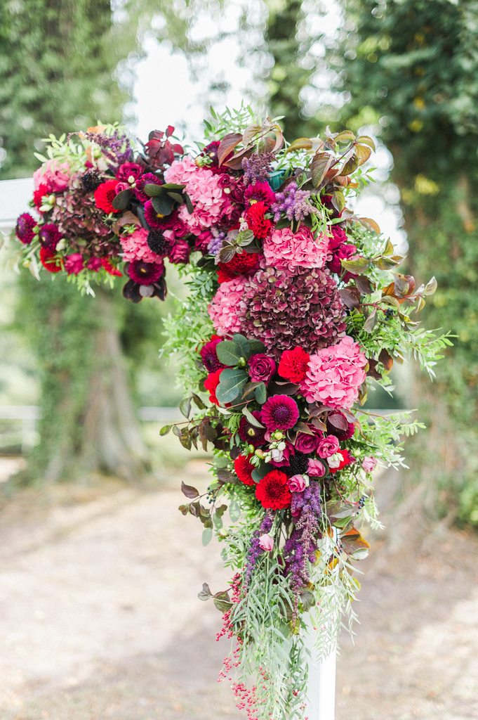 wedding ceremony, flower arch, burgundy flowers